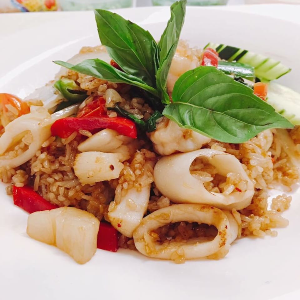 Sala Thai's fried rice with squid, red peppers, and basil on a white plate.
