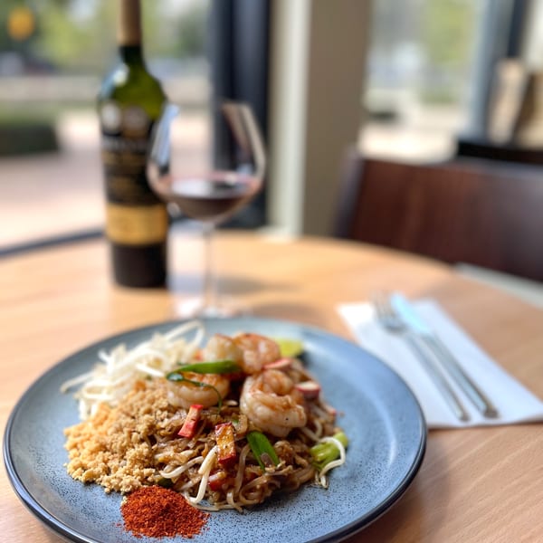 Sala Thai's Pad Thai with shrimp, bean sprouts, crushed peanuts, and chili powder, with wine.