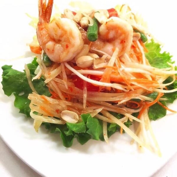 Sala Thai's papaya salad with shrimp, peanuts, and green beans on a bed of lettuce.