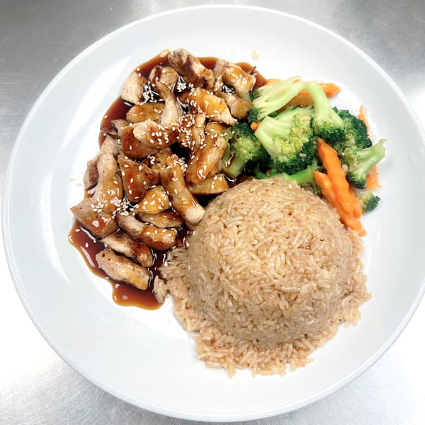 Sala Thai's chicken teriyaki with sesame seeds, brown rice, and steamed broccoli and carrots.