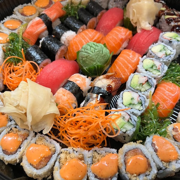 A large platter of Sala Thai sushi and sashimi, including rolls, nigiri, and garnishes.