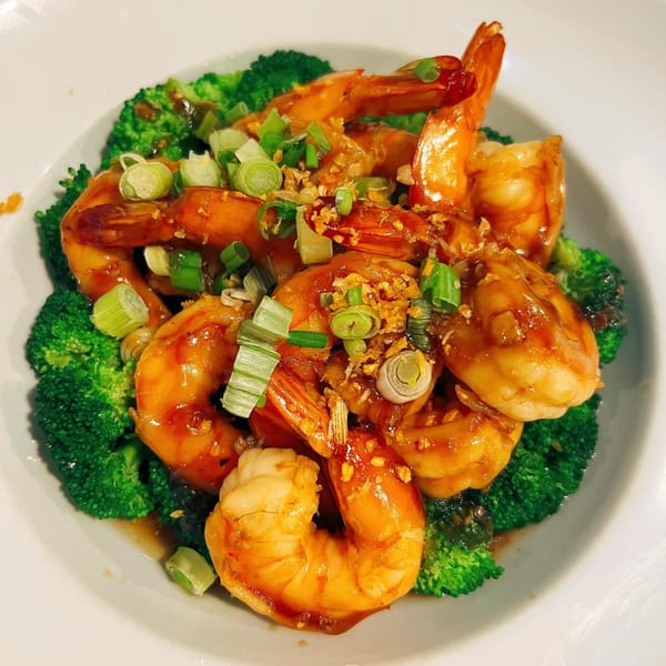 Sala Thai's garlic prawns with broccoli, garnished with green onions and fried garlic.