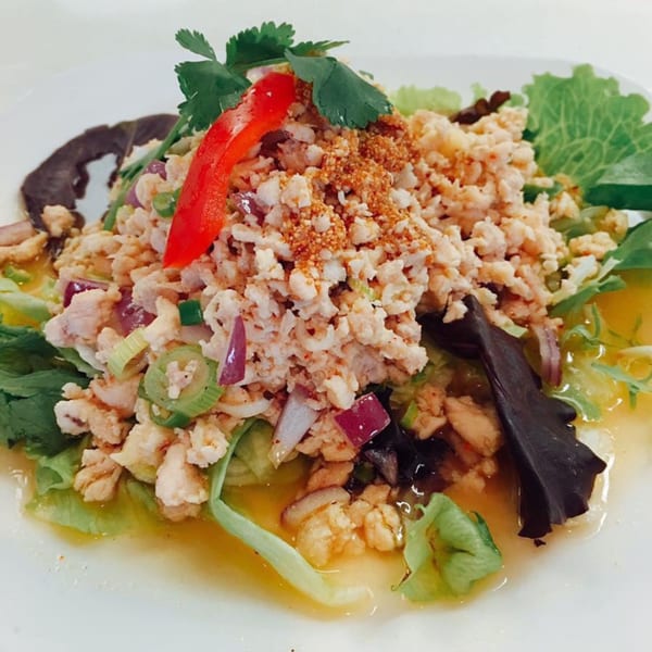 Sala Thai's Larb Gai, a vibrant Thai salad with minced chicken, herbs, and spices on lettuce.