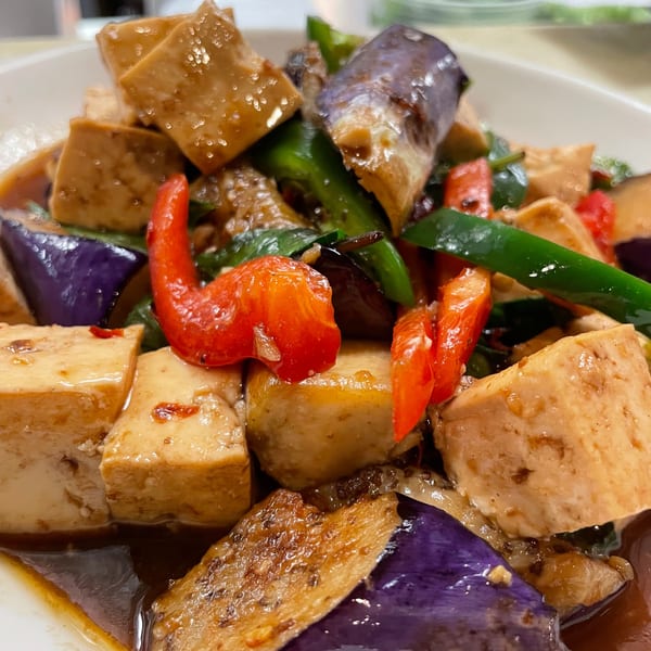 Close-up of Sala Thai's stir-fried tofu with eggplant, red bell peppers, and green beans in sauce.